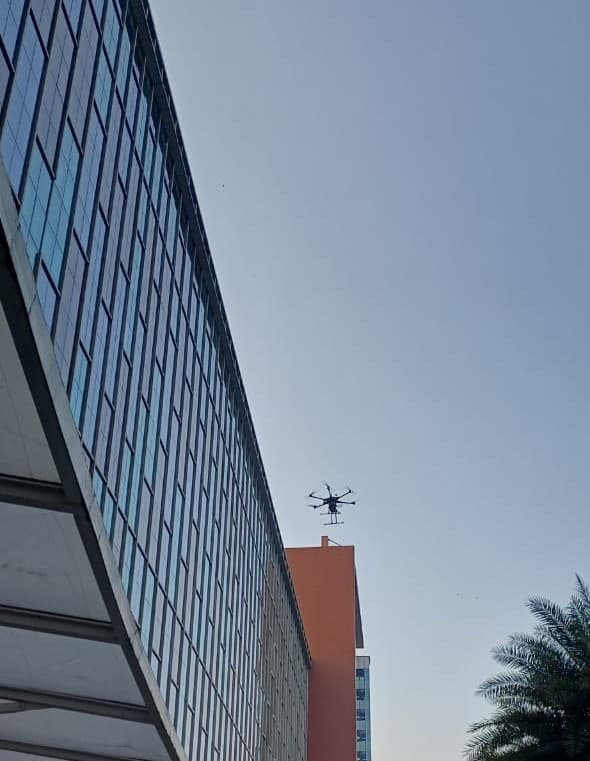 Drone cleaning a building facade